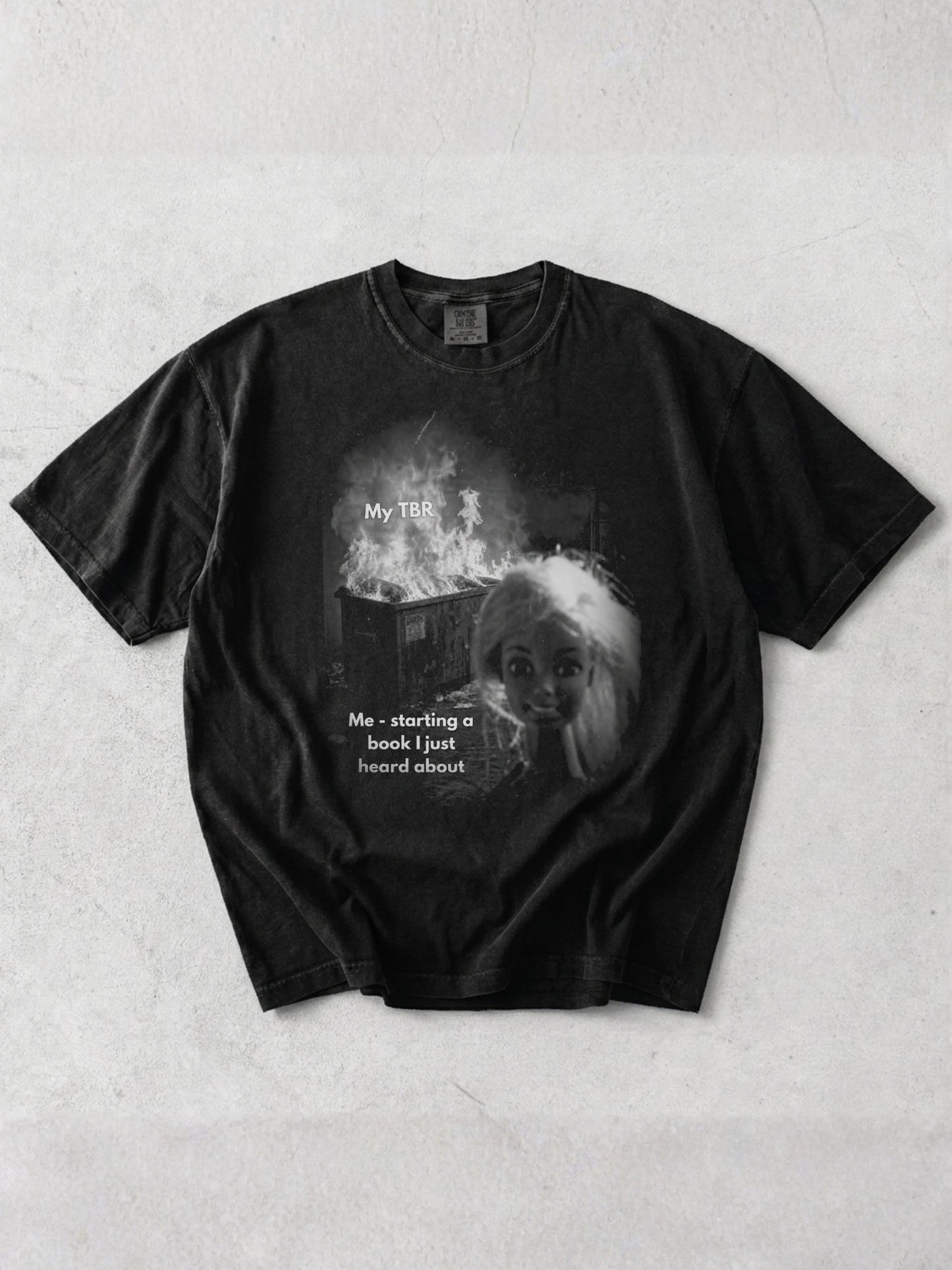 Graphite Comfort Colors shirt featuring a funny reader meme design with a burning My TBR pile and Me starting a book I just heard about text, humorous book lover shirt for readers with an endless to be read list
