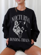 black crewneck sweatshirt with Nocturna Bonding Trials wolf graphic inspired by fantasy academy and romantasy books