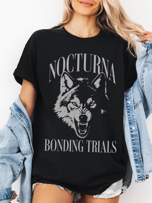 black oversized t shirt with Nocturna Bonding Trials wolf graphic styled with denim jacket and shorts
