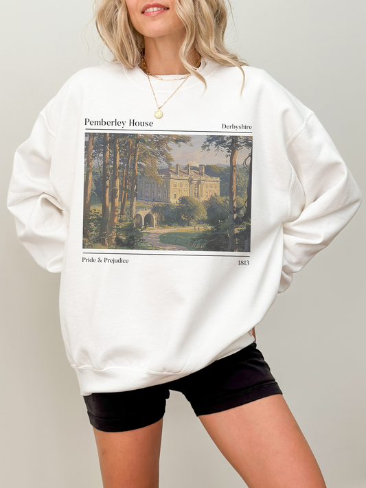 woman wearing white sweatshirt with painting of Pemberley House and Jane Austen book details