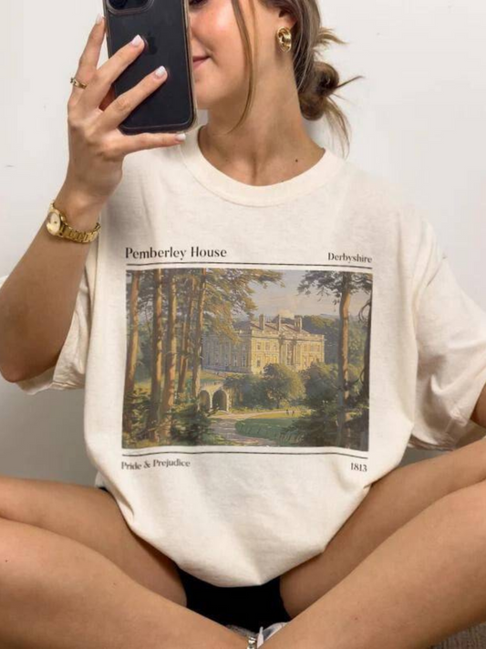 woman sitting in natural color t-shirt with classic painting of Pemberley and 1813 Pride & Prejudice text