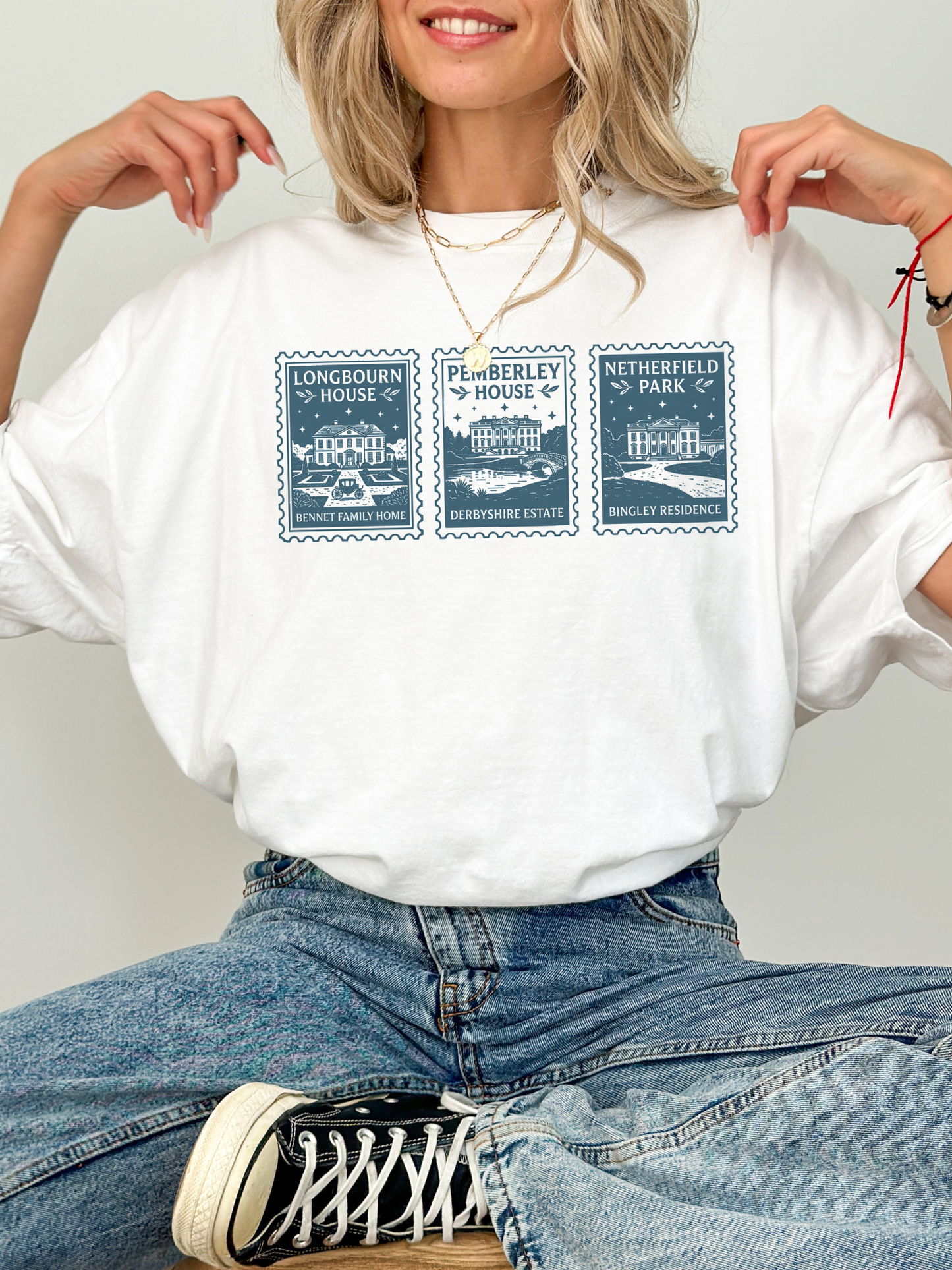 woman wearing white t shirt styled with jeans featuring Pride and Prejudice stamp design with Longbourn House Pemberley House and Netherfield Park