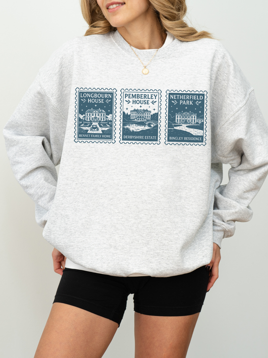 woman wearing grey sweatshirt featuring vintage stamp design of Longbourn House Pemberley House and Netherfield Park from Pride and Prejudice