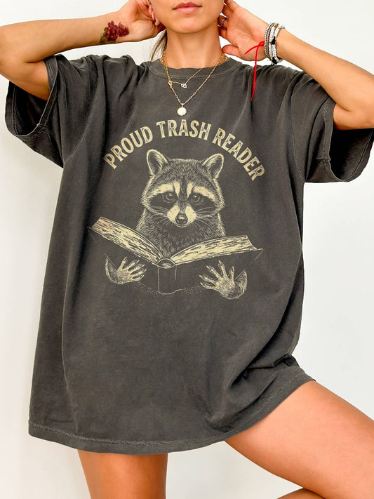 Person wearing a gray oversized t-shirt with 'overstimulated' text on a white background
