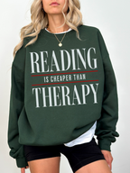 forest green reading is cheaper than therapy sweatshirt for readers and bookworms with large typography graphic design