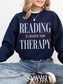 navy blue oversized reading is cheaper than therapy sweatshirt with aesthetic typography design for book lovers and readers