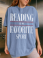 woman wearing blue jean reading is my favorite sport comfort colors t shirt posing in elevator with casual oversized book lover outfit