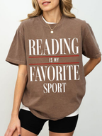 woman wearing espresso reading is my favorite sport comfort colors t shirt with relaxed fit styled with black shorts minimalist outfit