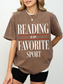 woman wearing espresso reading is my favorite sport comfort colors t shirt with relaxed fit styled with black shorts minimalist outfit