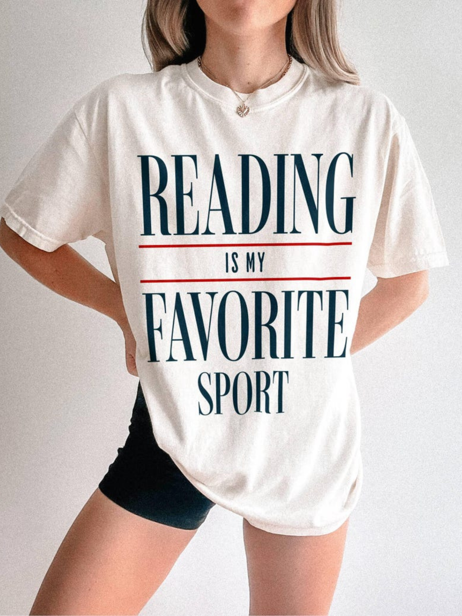 model wearing ivory reading is my favorite sport t shirt with minimal typography design styled in neutral aesthetic outfit