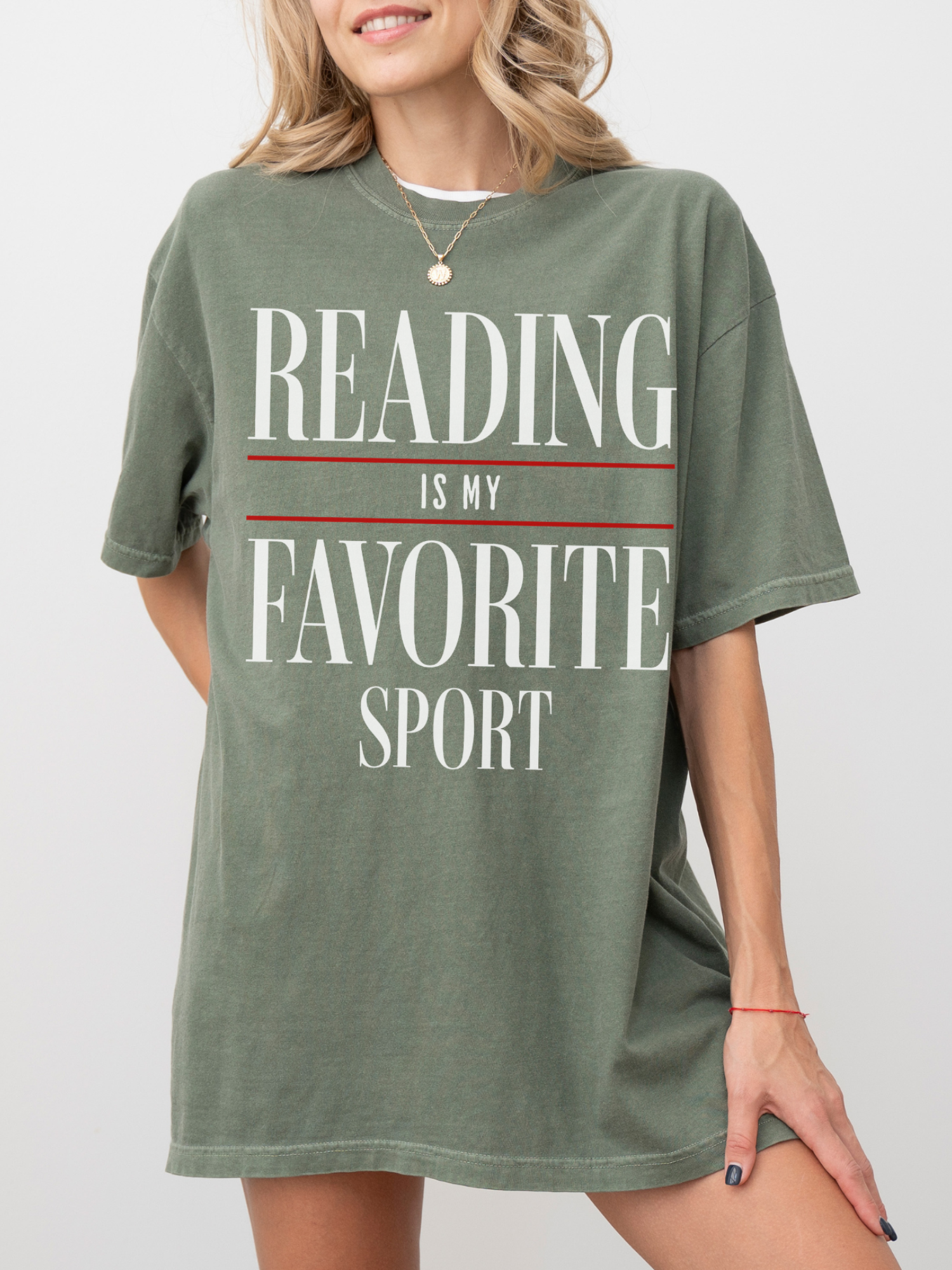 woman wearing moss reading is my favorite sport comfort colors t shirt with oversized fit and casual everyday styling