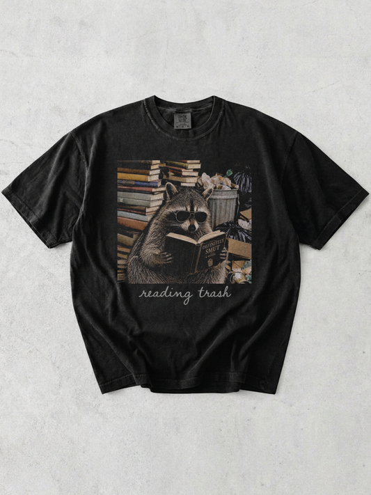 graphite comfort colors raccoon book lover shirt with funny reading trash graphic and stacks of books aesthetic design
