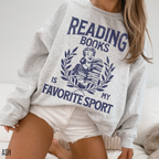 woman wearing an ash grey sweatshirt that says reading books is my favorite sport with a vintage book lover design