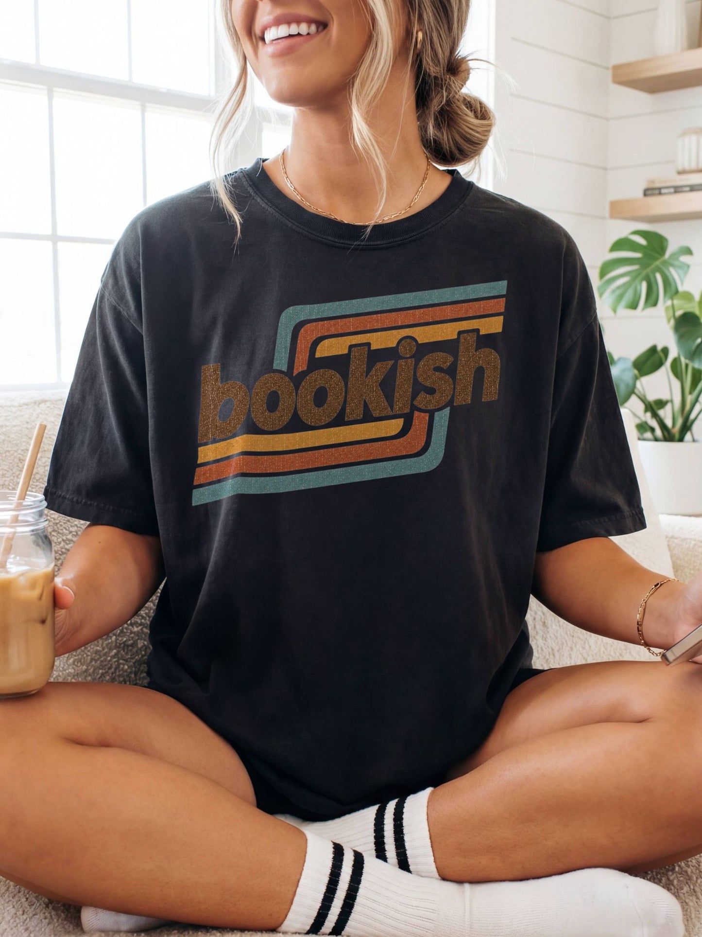 woman wearing a black retro bookish graphic t-shirt with vintage stripe design