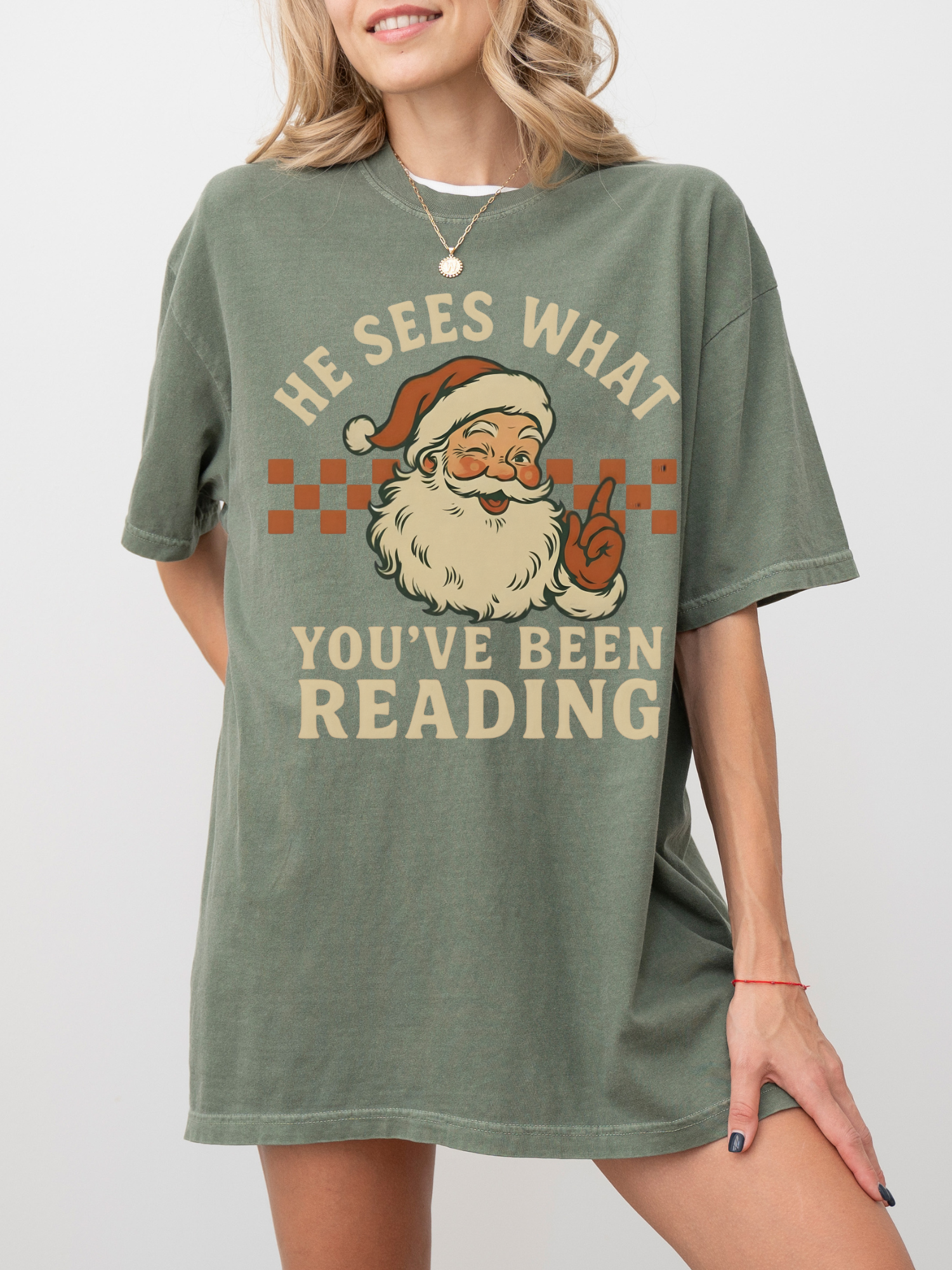 Woman smiling in green Comfort Colors shirt with funny Santa book reader Christmas graphic