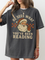 Woman in oversized pepper t-shirt with vintage Santa and cheeky reading quote, standing against white wall