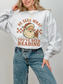 girl wearing ash grey sweatshirt with santa graphic and spicy bookish saying