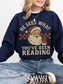 girl sitting cross-legged in navy sweatshirt with vintage santa graphic and bookish quote