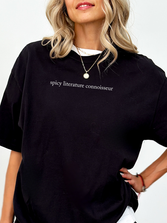 Minimalist black Comfort Colors t-shirt with white “spicy literature connoisseur” print, styled with white undershirt.