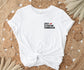 white t-shirt tied at the waist with spicy literature connoisseur design laid on woven boho rug