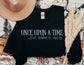 folded black sweatshirt on book-themed backdrop with text once upon a time but make it spicy