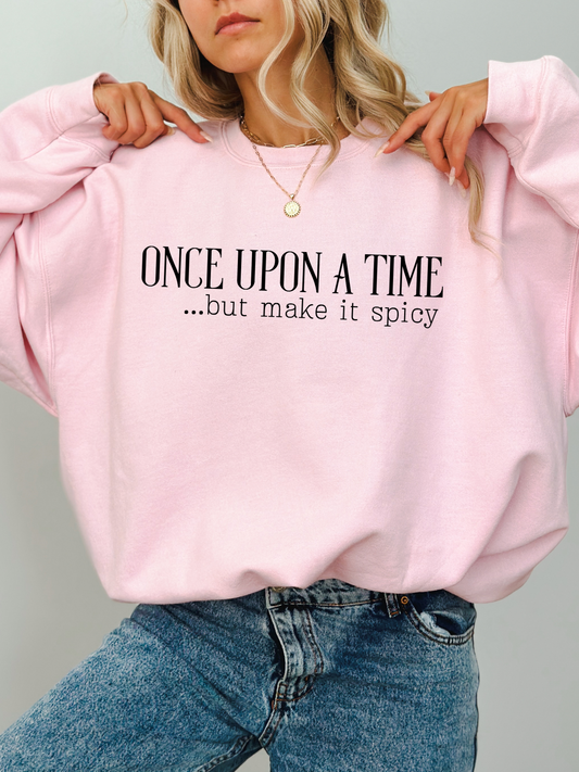 woman wearing light pink sweatshirt with once upon a time but make it spicy text, styled with gold necklace