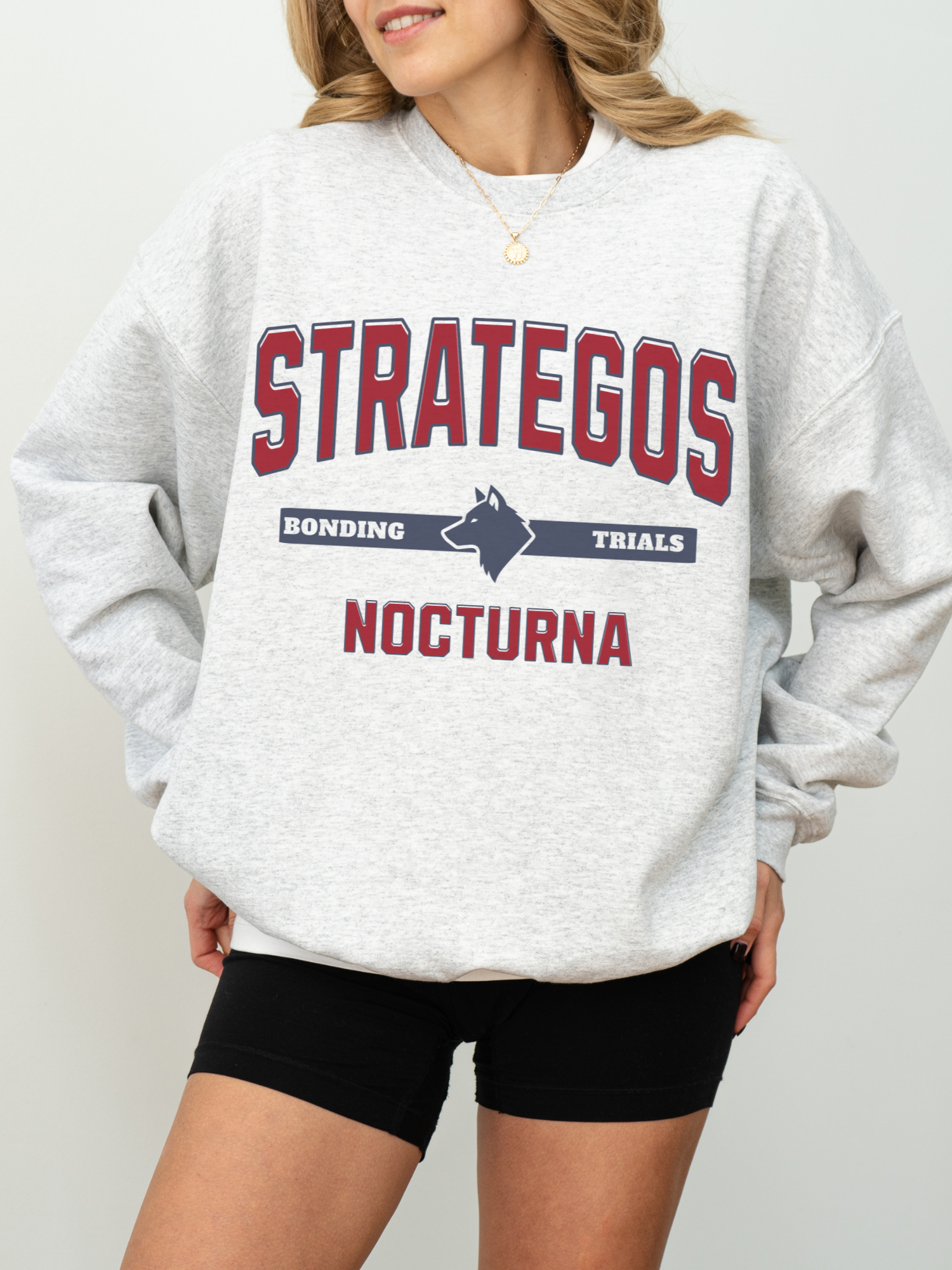 ash gray sweatshirt with Strategos Nocturna collegiate fantasy graphic and bonding trials wolf emblem