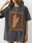 A woman wearing an oversized pepper T-shirt with a ghost reading books at a library and the text 'SUPPORT YOUR LOCAL BOOKSTORE'.