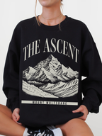 black crewneck sweatshirt featuring The Ascent Mount Wolfsbane mountain graphic design inspired by fantasy adventure books