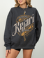 Dark heather grey crewneck with intricate sword and scroll design from The Moon Palace, styled simply for cozy reading days or book club outfits.