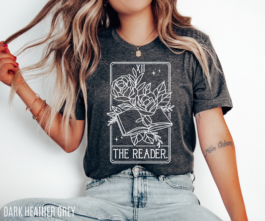 woman wearing dark heather grey tarot The Reader t-shirt with white floral book design