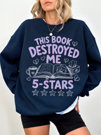 woman wearing navy blue sweatshirt with this book destroyed me 5 stars graphic and emotional reader themed illustration