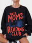 woman wearing black tired moms reading club sweatshirt with retro book lover design featuring coffee cup open book and flowers