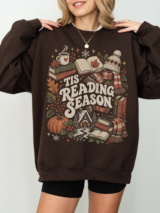 Dark Chocolate Gildan sweatshirt featuring a vintage Tis Reading Season graphic with books, coffee, pumpkin, fall leaves, scarf, winter hat and cozy cottage, book lover sweatshirt for readers
