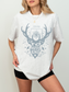 Model in an ash grey “To Whatever End” t-shirt with fantasy bookish design, styled casually with black shorts indoors

