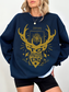 woman wearing navy blue sweatshirt with gold Terrasen crest and the quote “To Whatever End” from Erilea lore

