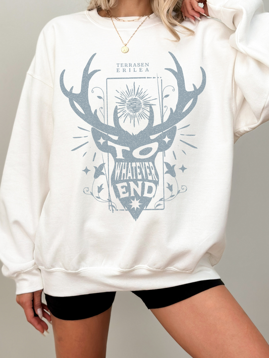 woman wearing white sweatshirt with blue "To Whatever End" antler crest design inspired by Terrasen and Throne of Glass

