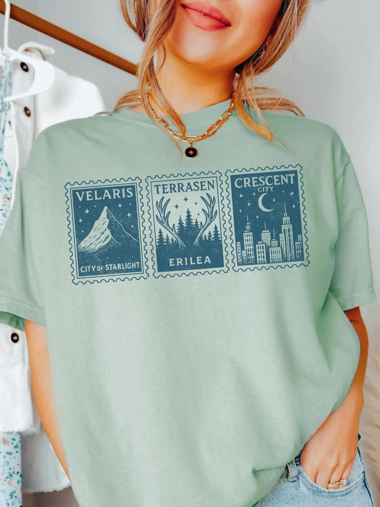 woman wearing bay fantasy book stamp t-shirt featuring Velaris, Terrasen, and Crescent City from Sarah J. Maas books