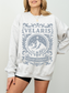 woman in an ash grey Velaris sweatshirt with light blue fantasy design inspired by ACOTAR’s City of Starlight
