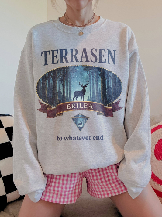 woman wearing a heather gray vintage terrasen sweatshirt with stag forest crest and erilea text
