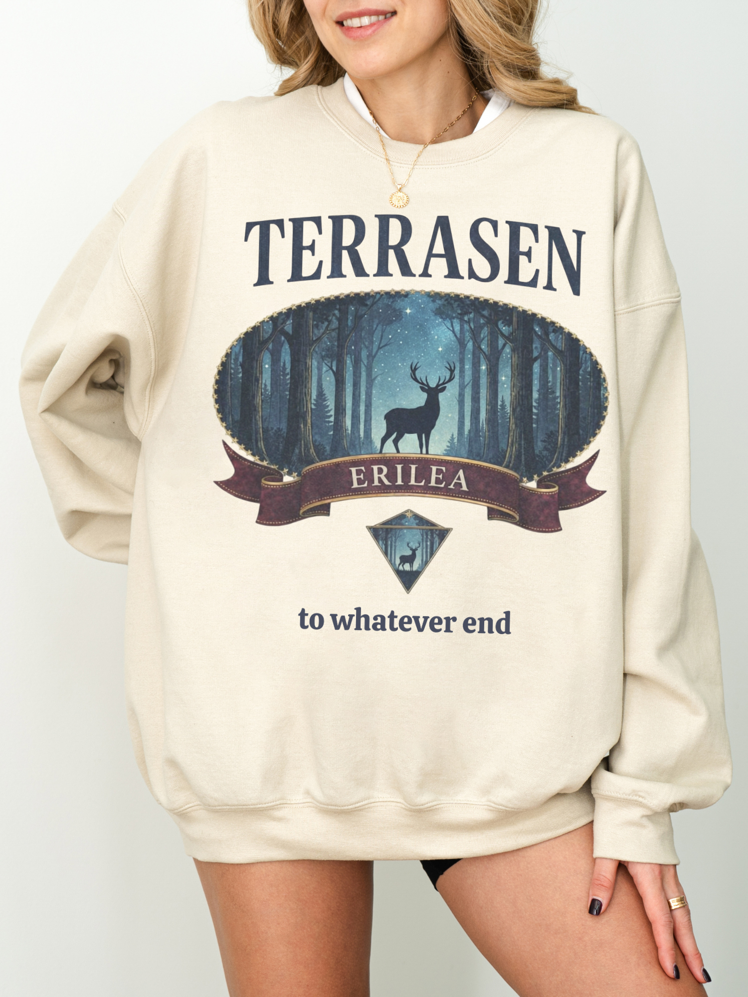 woman wearing a sand colored vintage terrasen sweatshirt featuring a stag in a night forest design