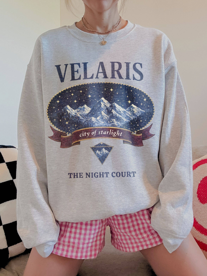 woman wearing a heather gray vintage velaris sweatshirt with starlit mountain artwork and night court text