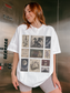 Woman wearing oversized white fantasy bookish t shirt featuring vintage postage stamp collage with dragon sword moon books flowers castle and enemies to lovers artwork inside an elevator