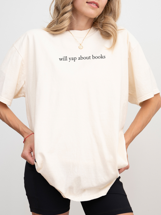woman wearing a natural t-shirt that says will yap about books in lowercase serif font
