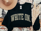 flatlay of black write on sweatshirt with rustic tan text, styled with hat and fall florals